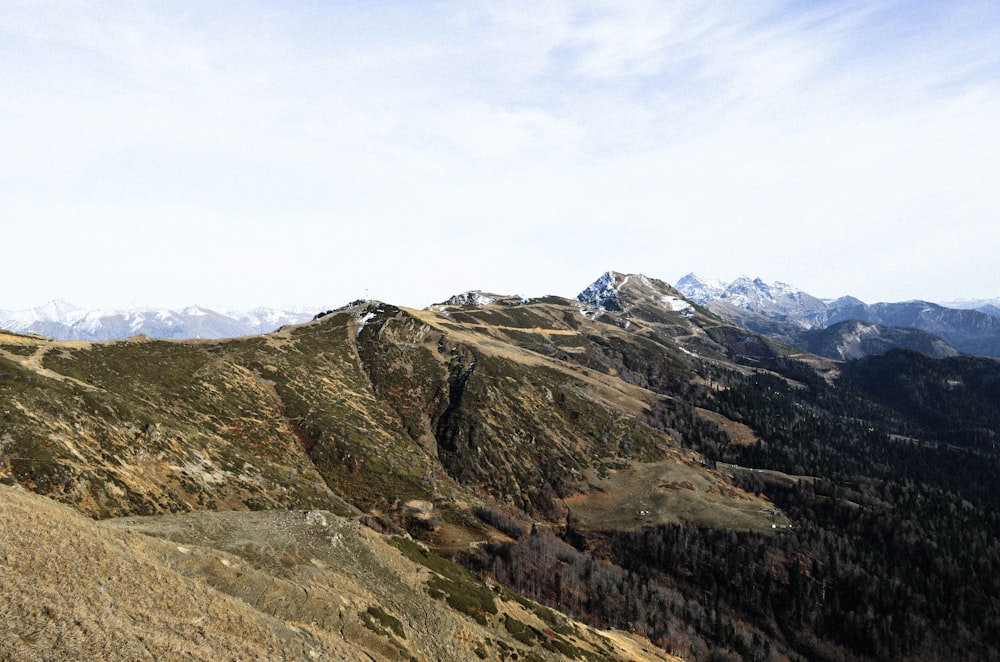 green and brown mountains under white clouds during daytime