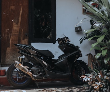 a black motorcycle parked in front of a building