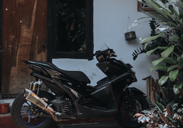 a black motorcycle parked in front of a building