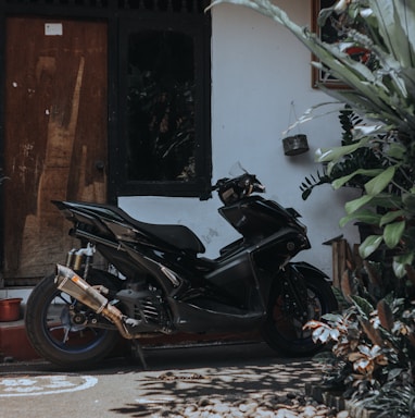 a black motorcycle parked in front of a building