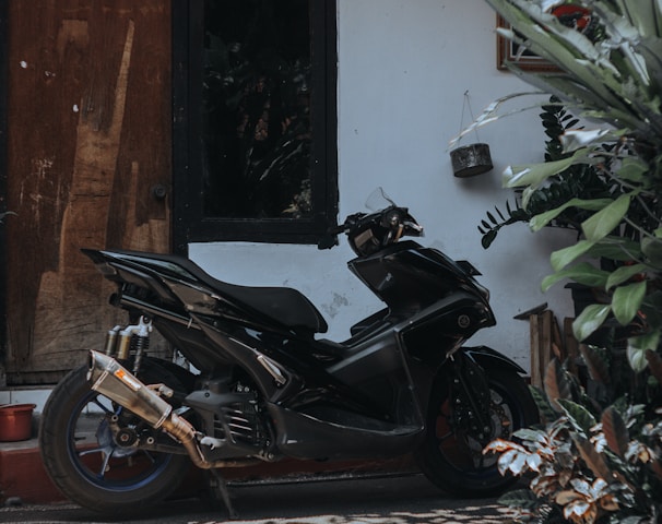 a black motorcycle parked in front of a building