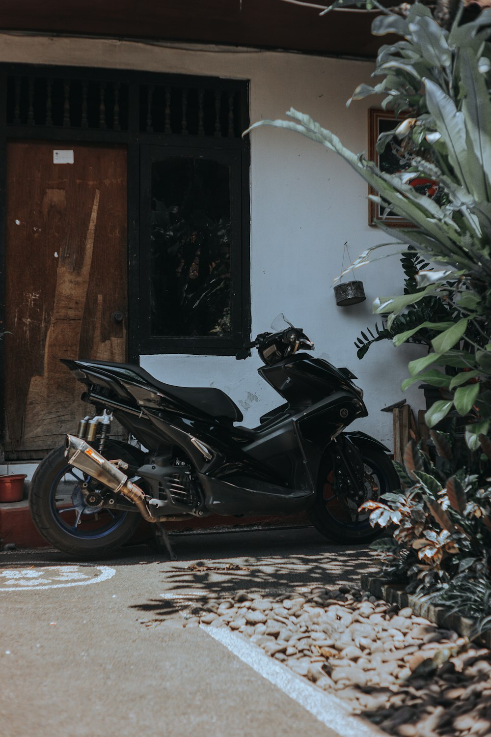 a black motorcycle parked in front of a building