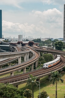 white and red train on rail road during daytime