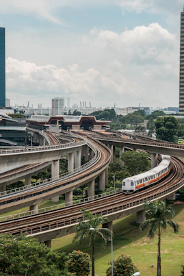 white and red train on rail road during daytime