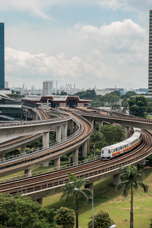 white and red train on rail road during daytime