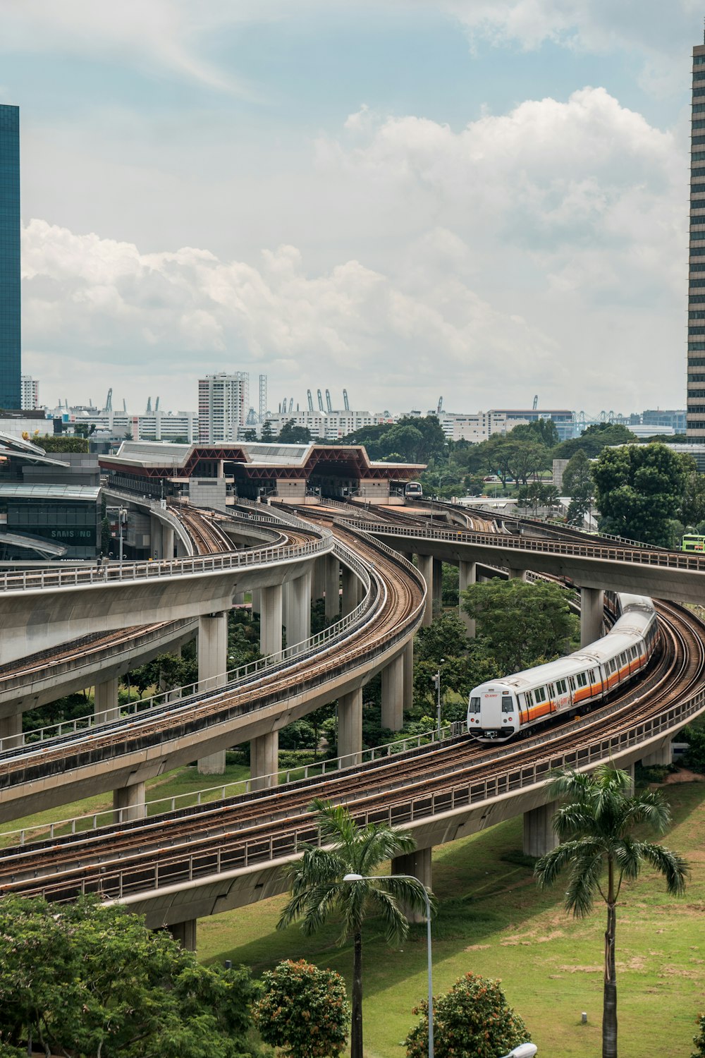 white and red train on rail road during daytime