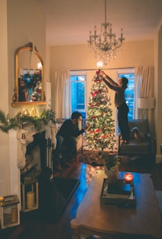 man in black suit standing beside woman in black long sleeve shirt