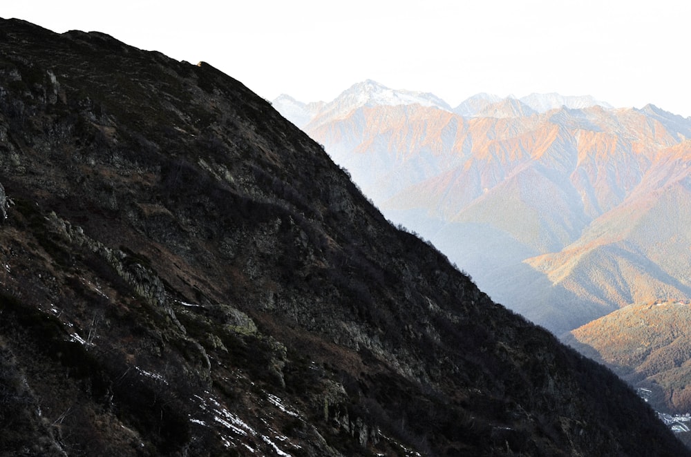 green and brown mountains under white sky during daytime