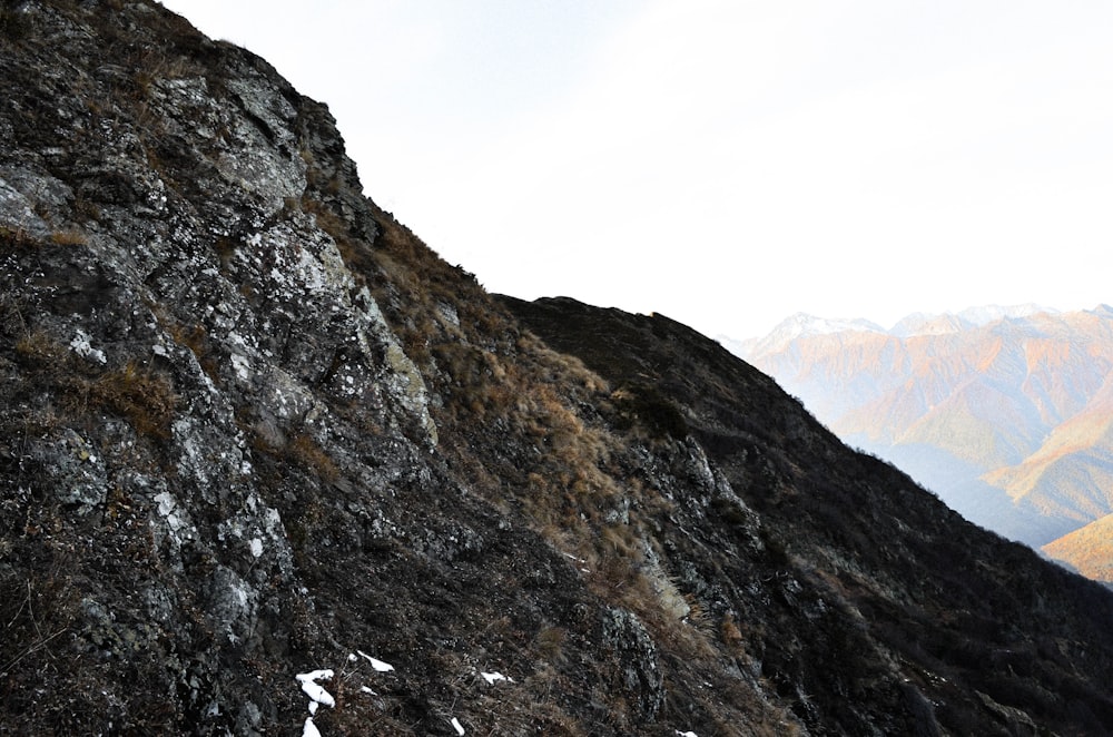 gray and brown rocky mountain under white sky during daytime