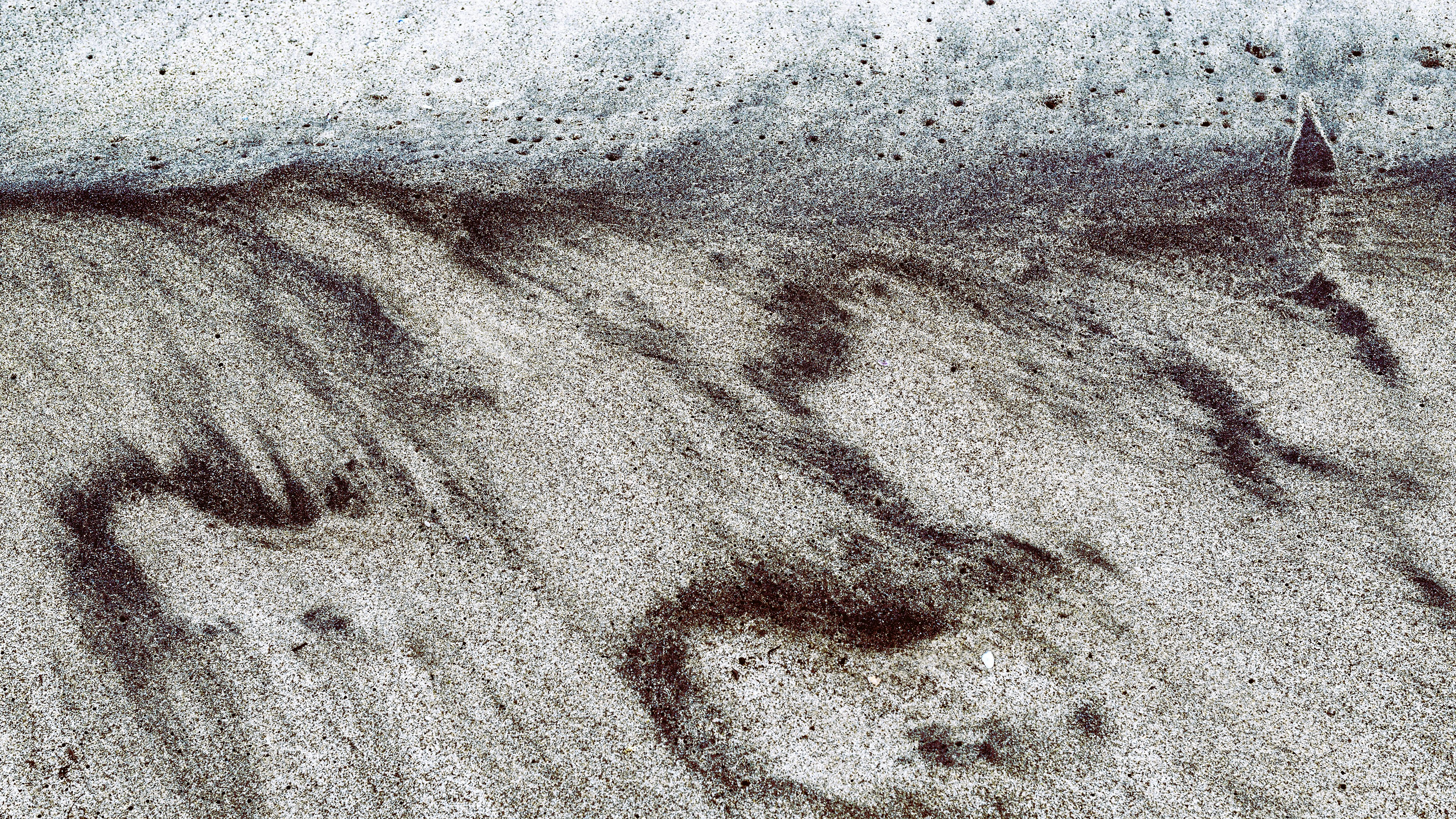 brown sand near body of water during daytime