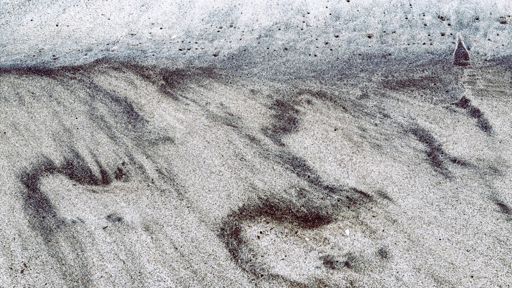 brown sand near body of water during daytime