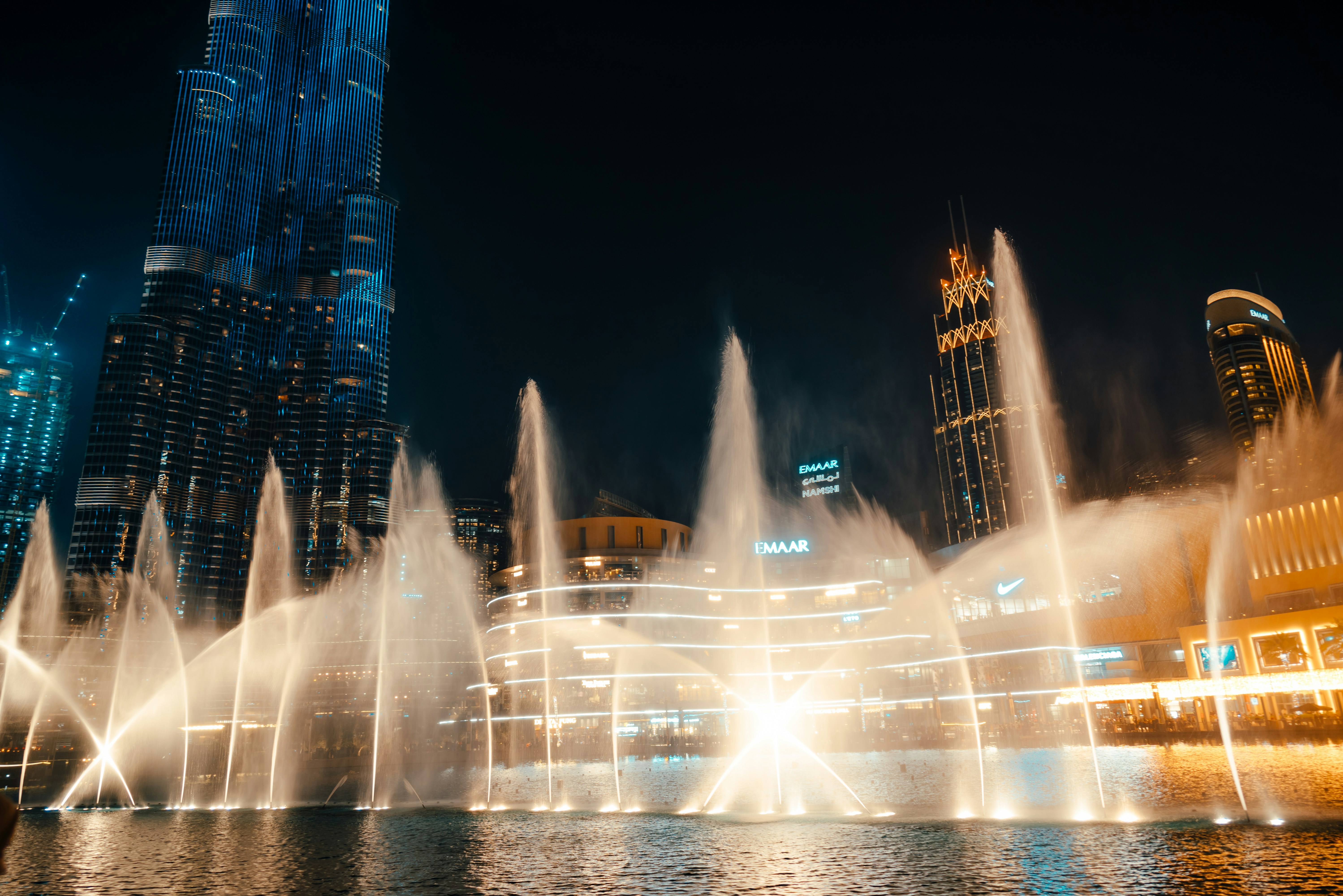 Dubai Fountain show at night with Burj Khalifa illuminated in background