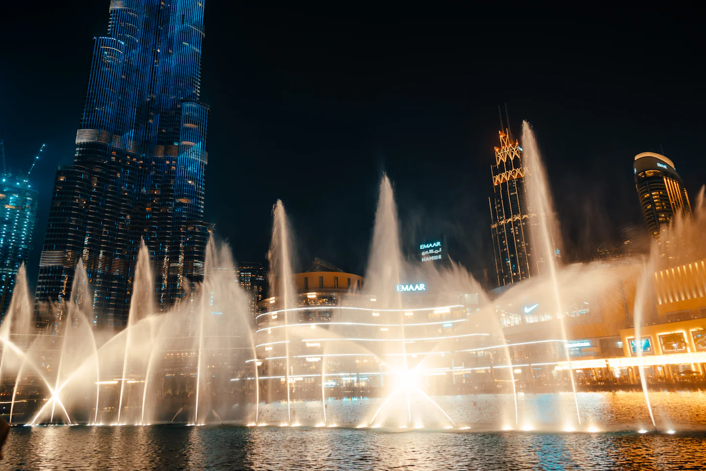 Illuminated fountain show at night
