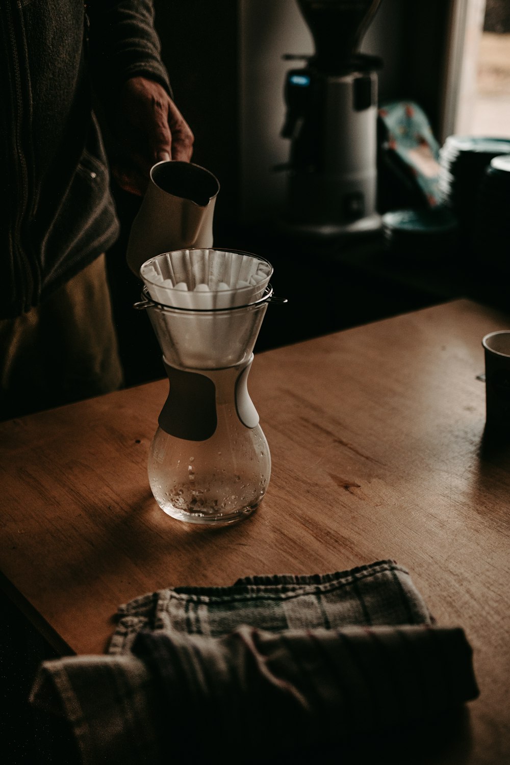 clear glass bottle on brown wooden table