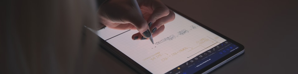 person writing on tablet