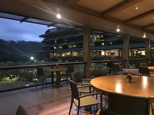 Terrace area with seating and flowering plants under soft natural light.