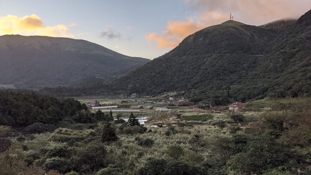 green grass field near mountain during daytime