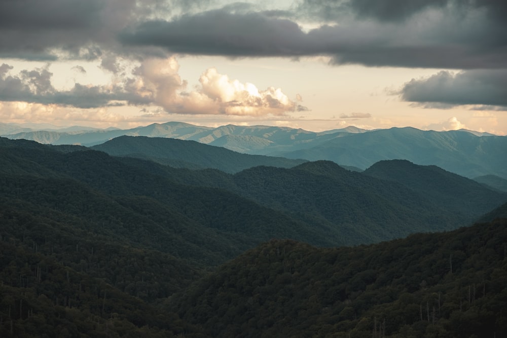 green mountains under white clouds during daytime