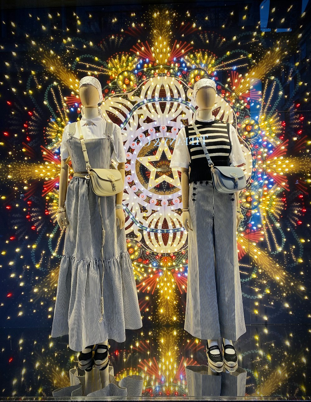 2 women in blue dress standing beside christmas tree