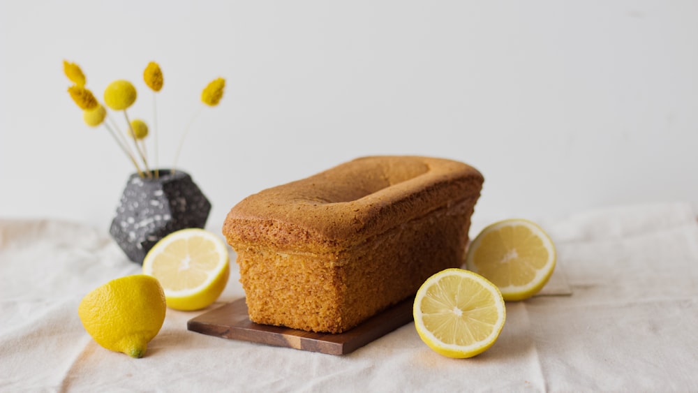 sliced lemon beside brown wooden container