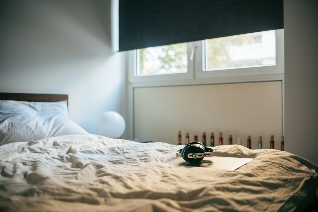 black and white round device on white bed