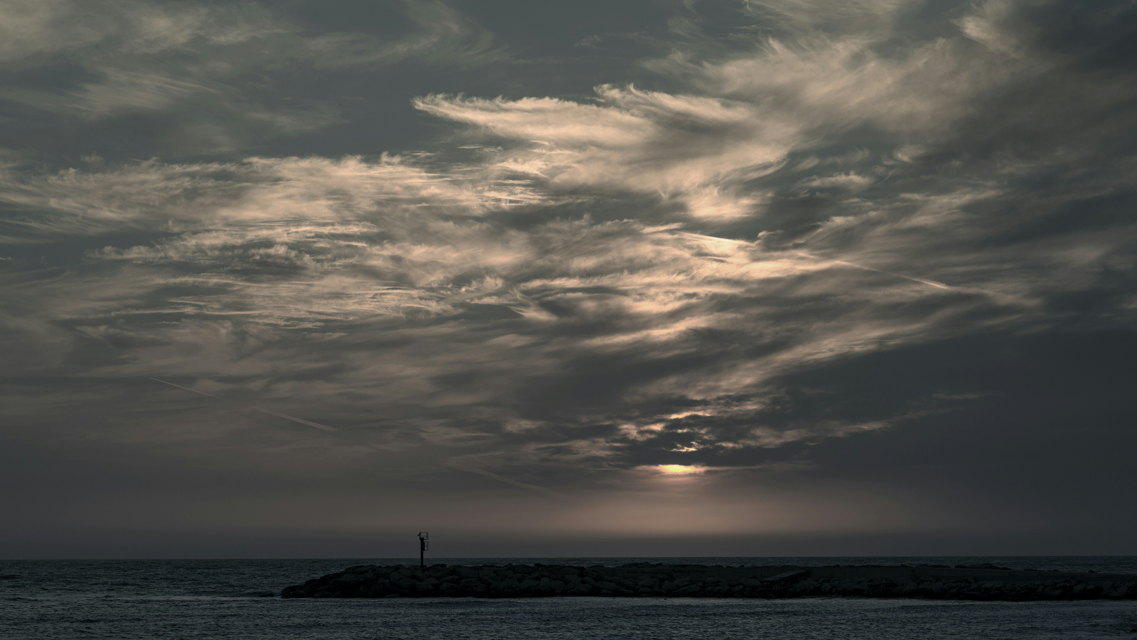 silhouette of person standing on beach during sunset