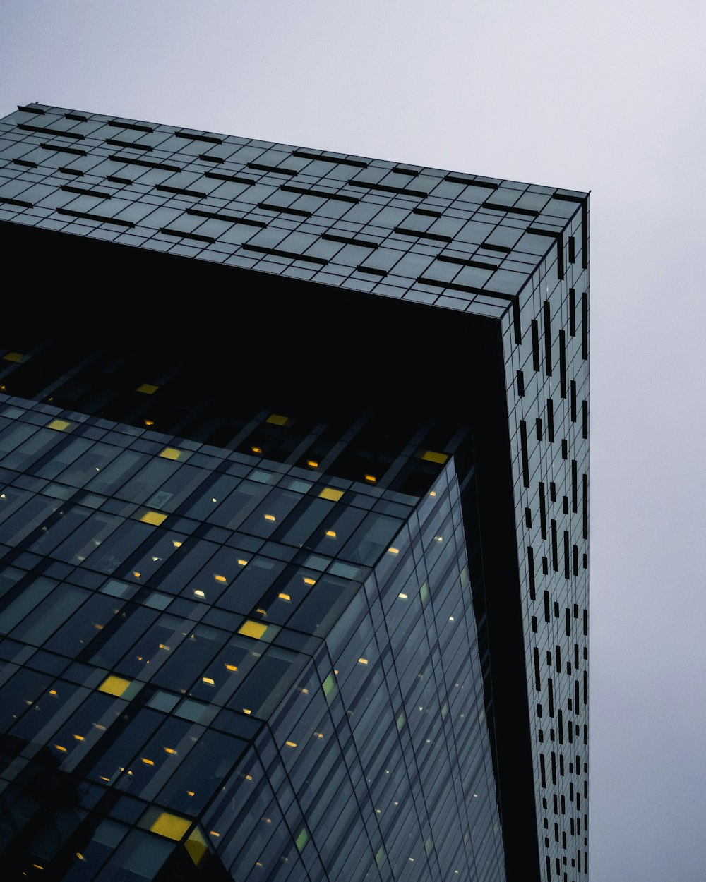 black and yellow glass walled high rise building