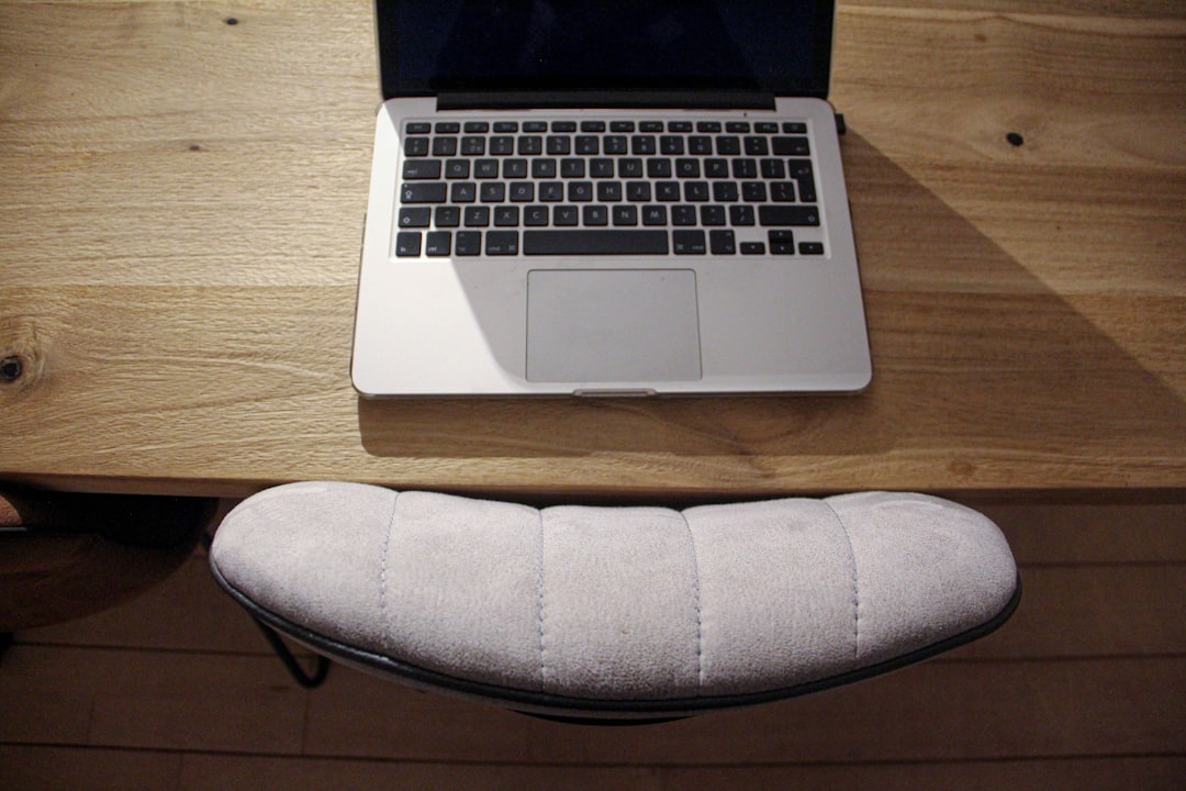 macbook pro on brown wooden table