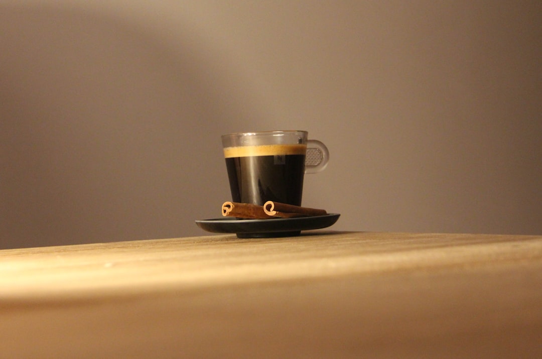 black and white ceramic mug on brown wooden table