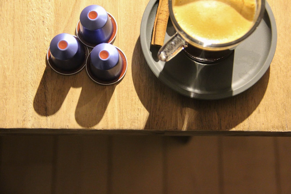 black and white ceramic mugs on brown wooden table