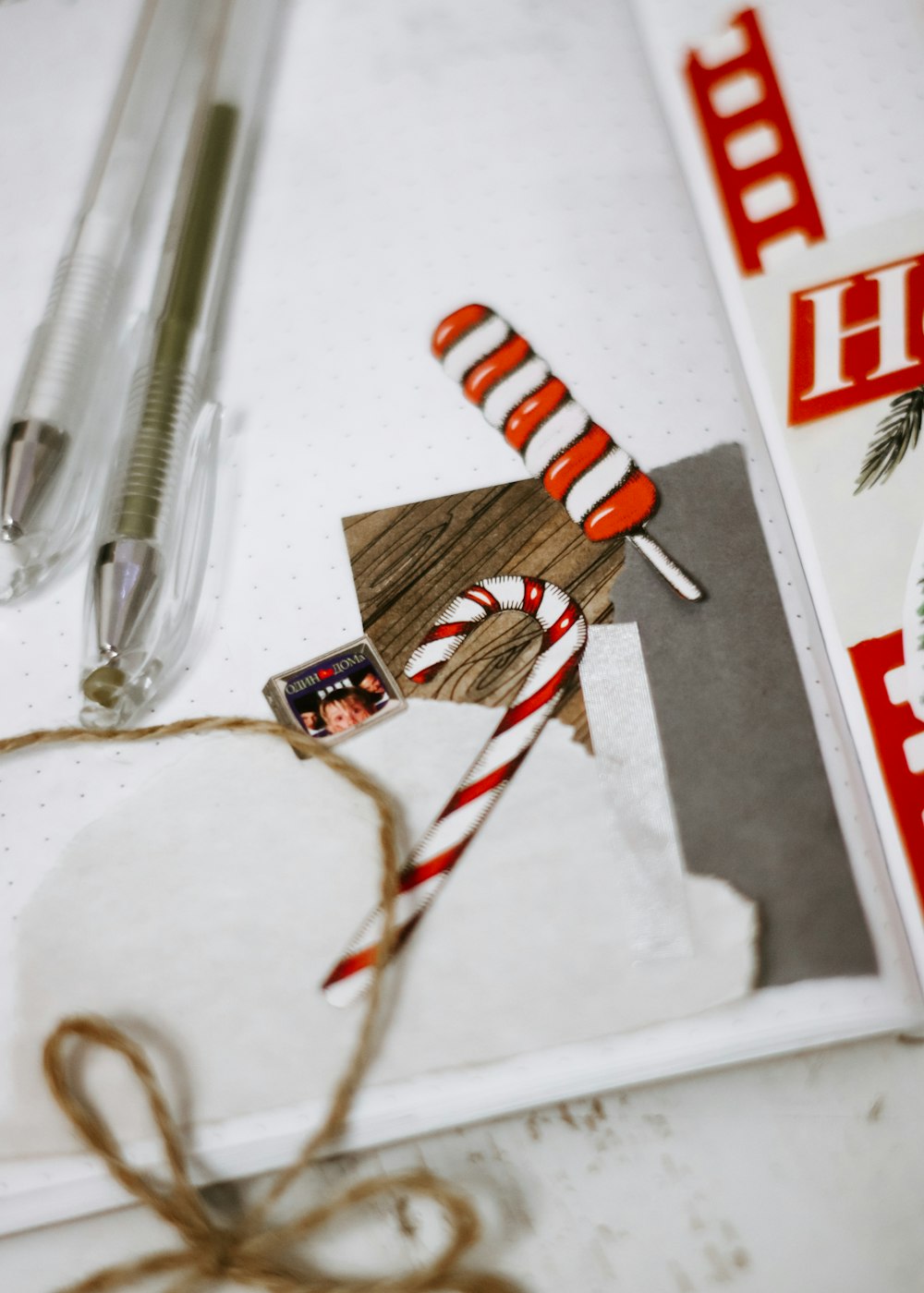 red and white striped candy cane beside black click pen