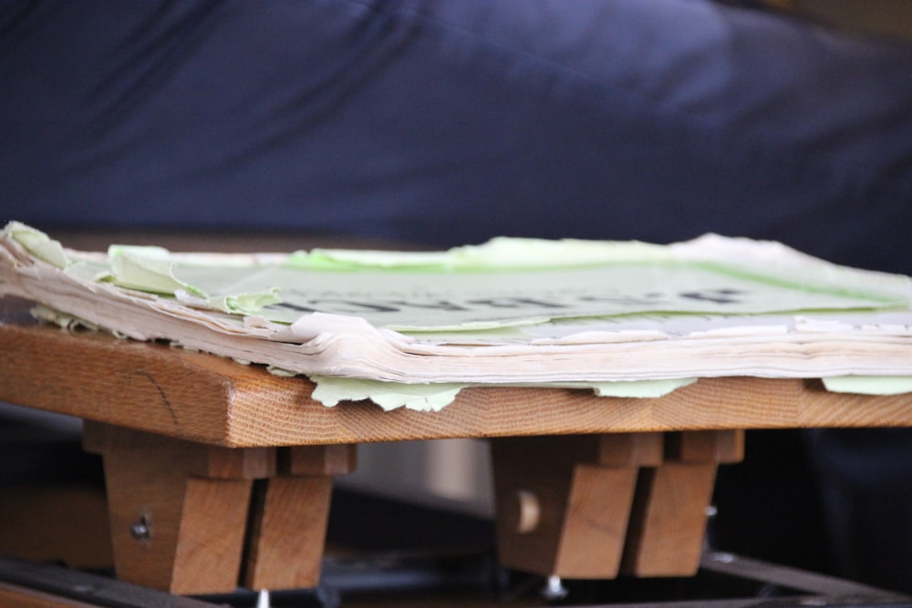 green and white textile on brown wooden table