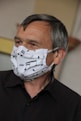 man in black suit jacket with white mask