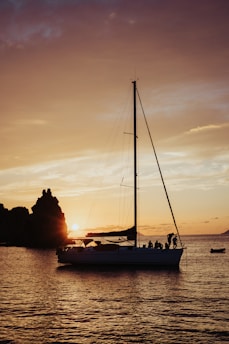 silhouette of people riding on boat during sunset