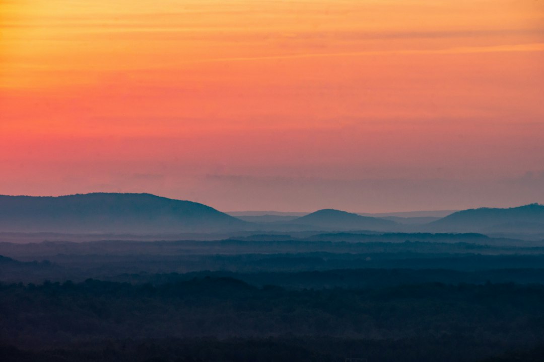 silhouette of mountains during sunset, Neon pink and coral horizon with the misty North Georgia mountains in the distance.<p></figure>•• See more at www.instagram.com/abigailducote ••