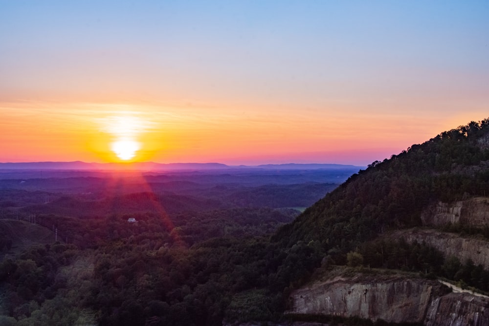 green and brown mountains during sunset