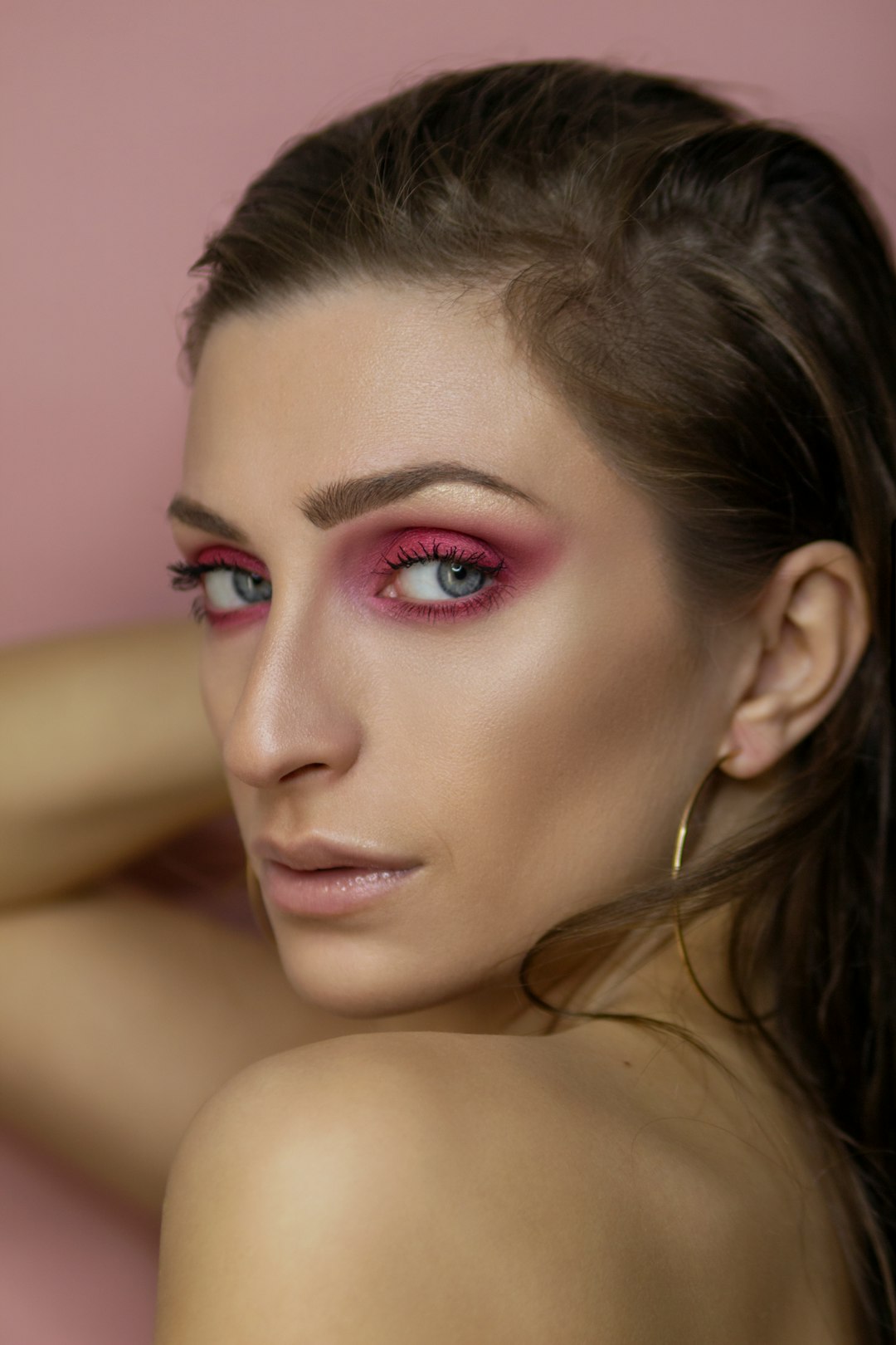 woman with pink lipstick and black mascara