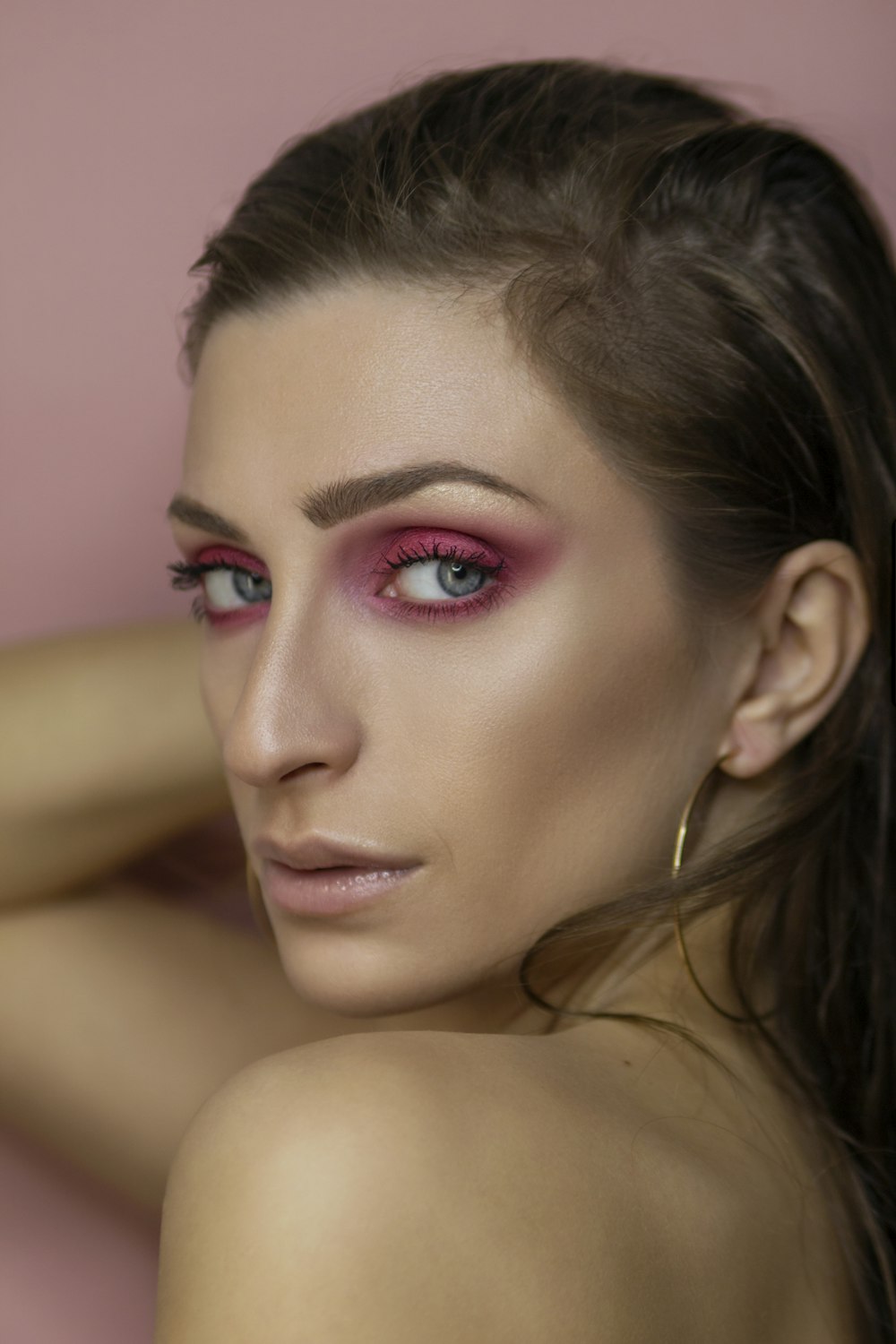 woman with pink lipstick and black mascara
