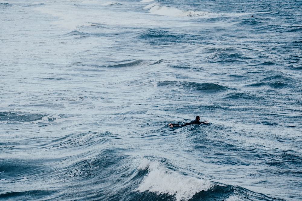 person surfing on blue sea during daytime