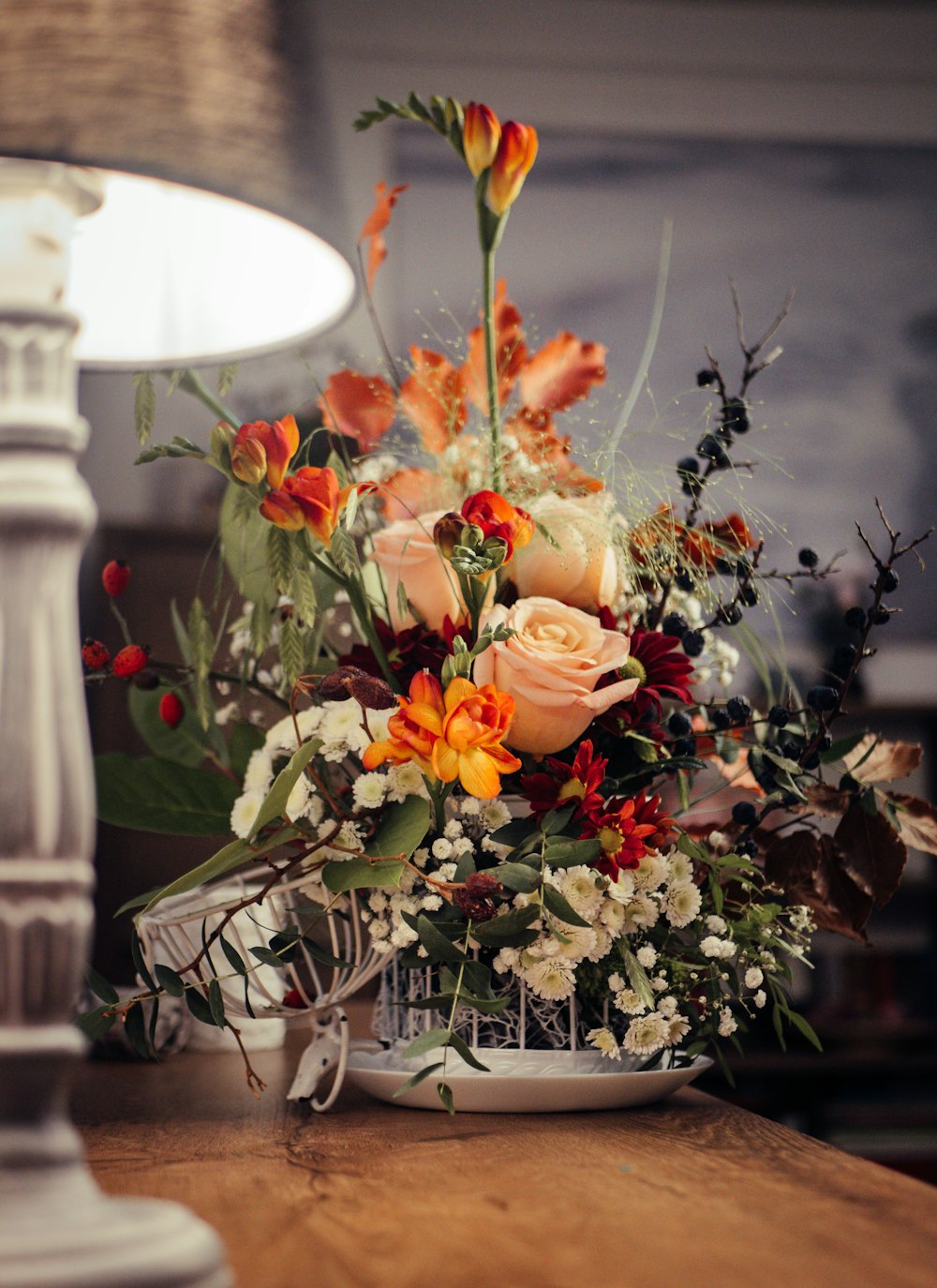 pink roses on white ceramic vase