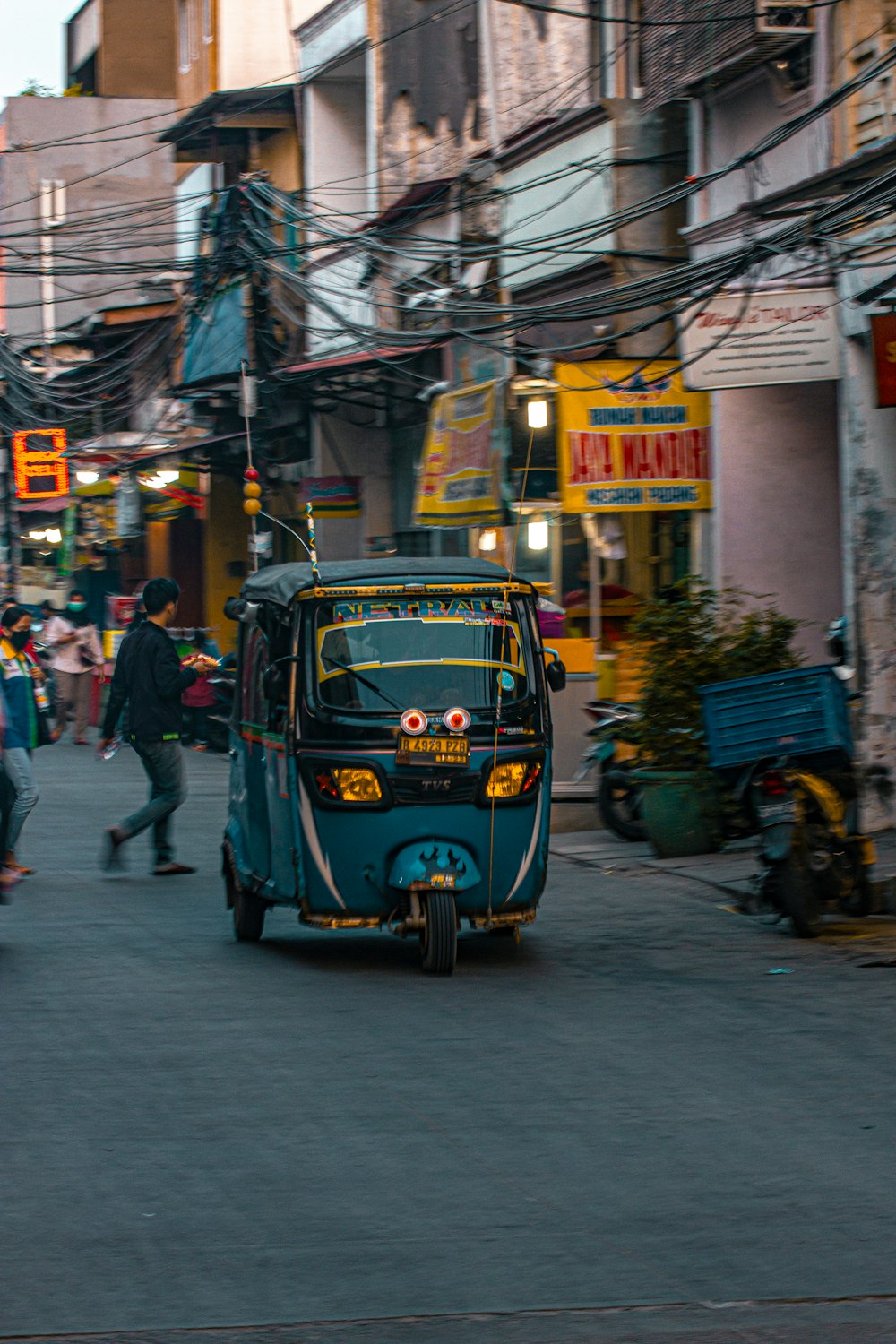 blue and yellow volkswagen t-1 parked on sidewalk during daytime