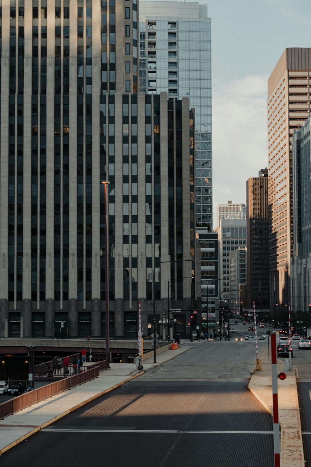 people walking on sidewalk near high rise buildings during daytime