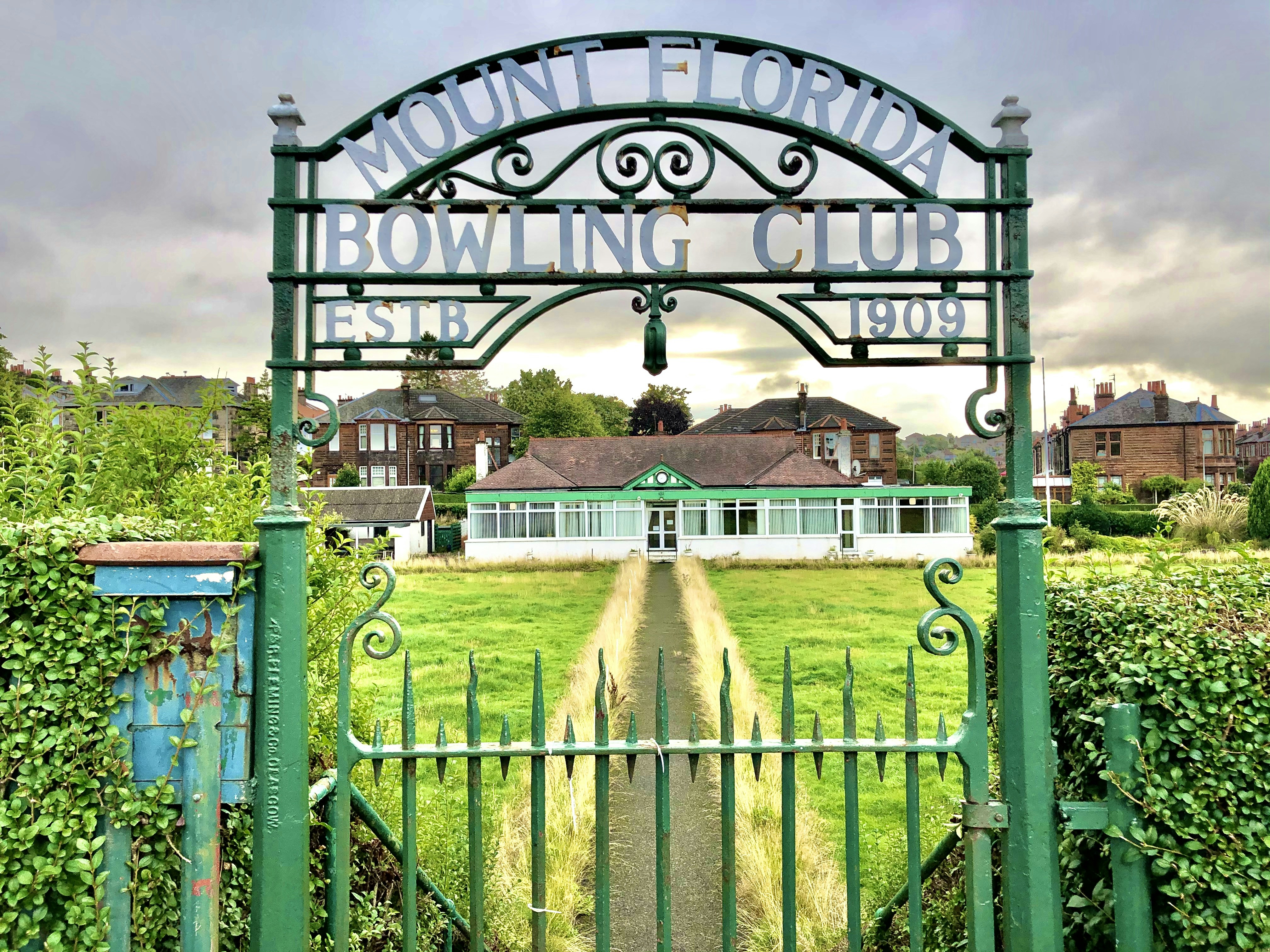 green metal fence with welcome to the beach signage