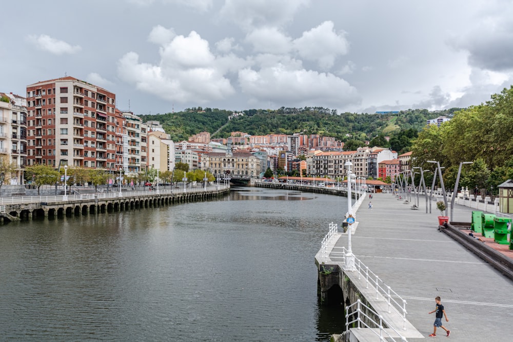 people walking on bridge over river during daytime