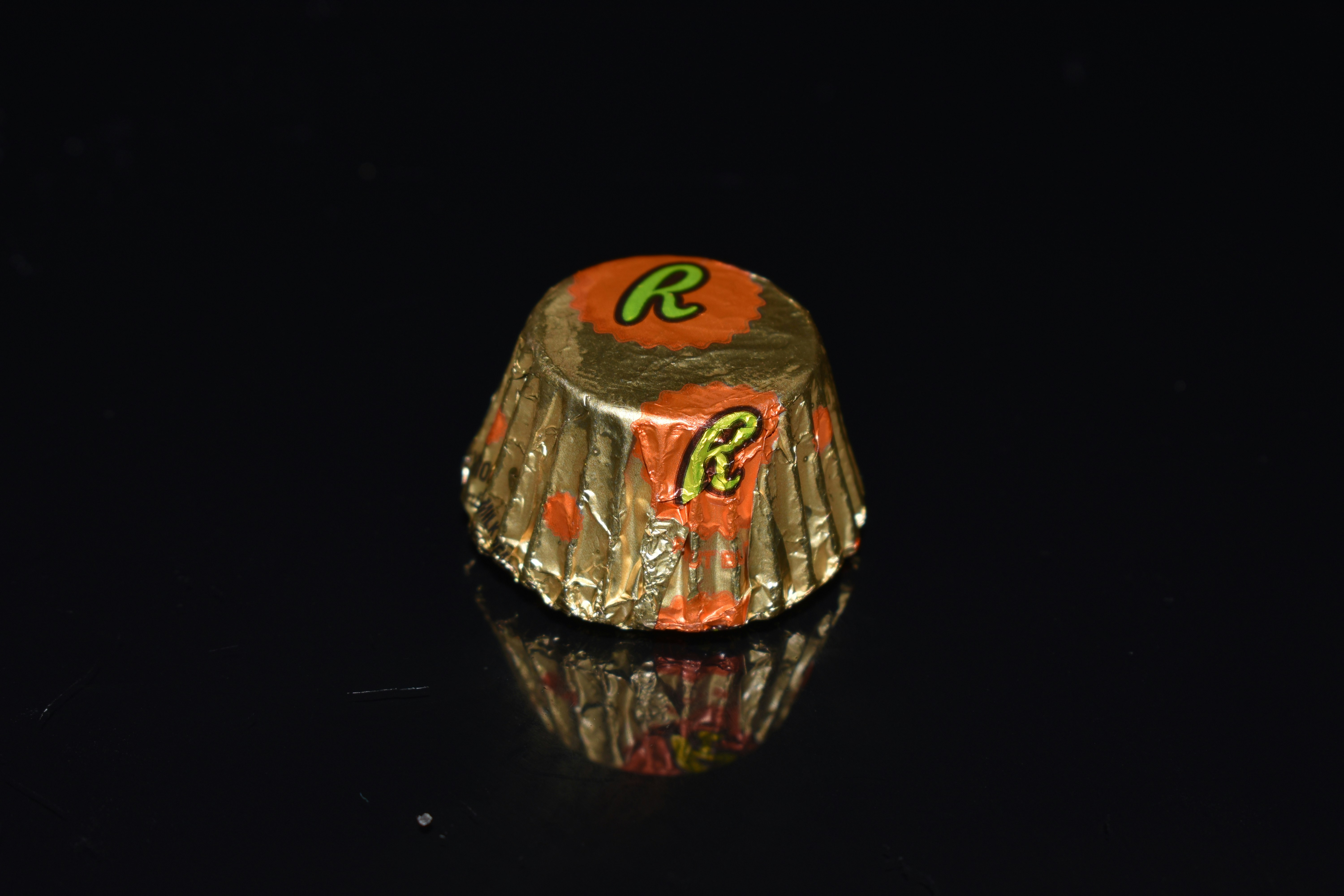 Reese's peanut butter cups in orange and brown foil wrapper