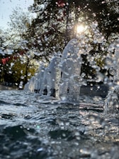 Close-up of bubbling water jets creating playful patterns in a public square