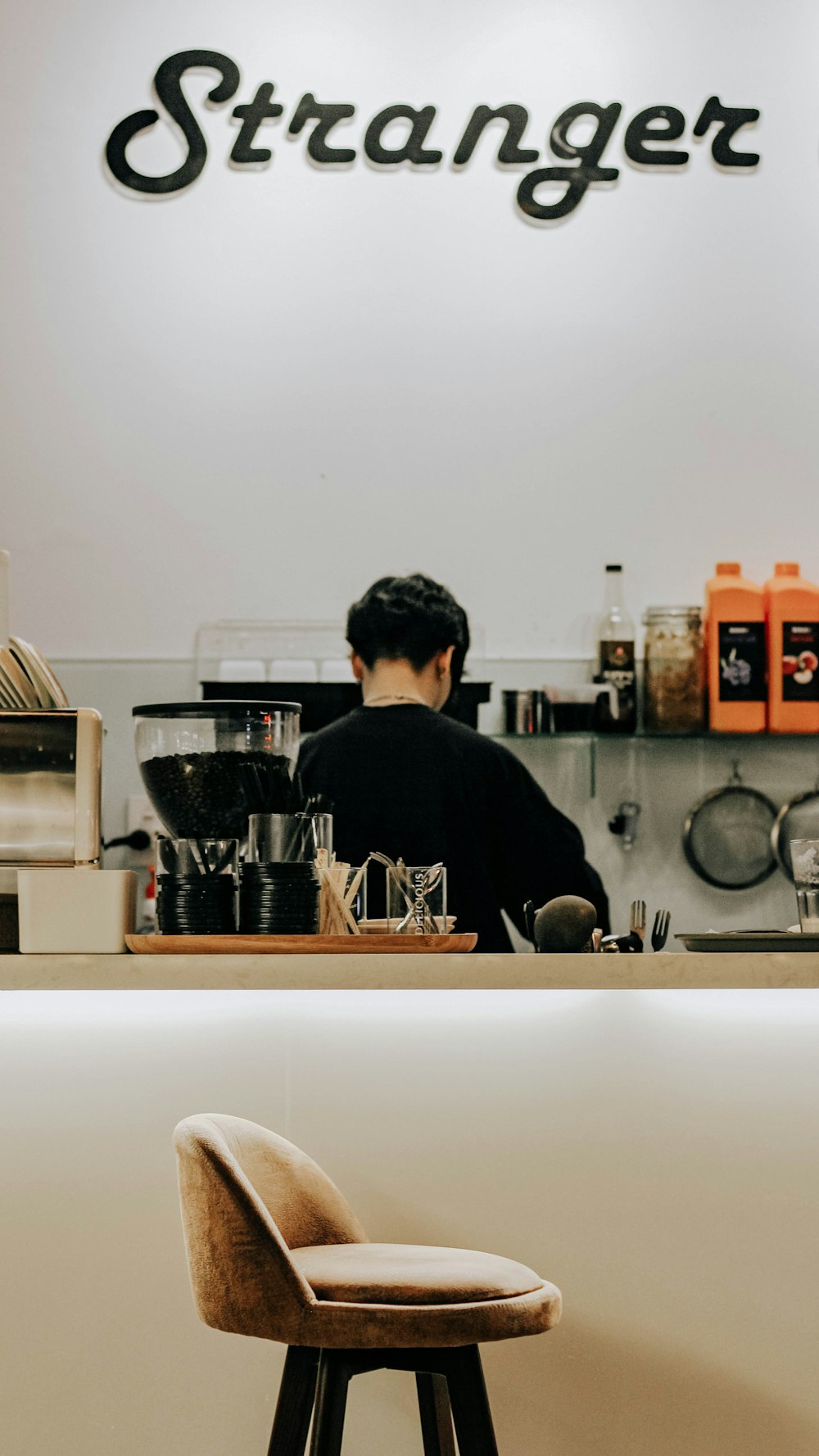 man in black sweater standing in kitchen