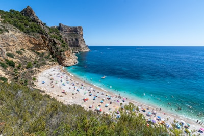 A vibrant beach with turquoise water and clear skies.