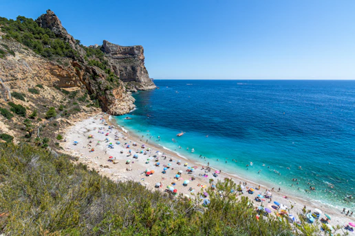 A vibrant Mexican beach with turquoise waters and golden sand under a clear blue sky.