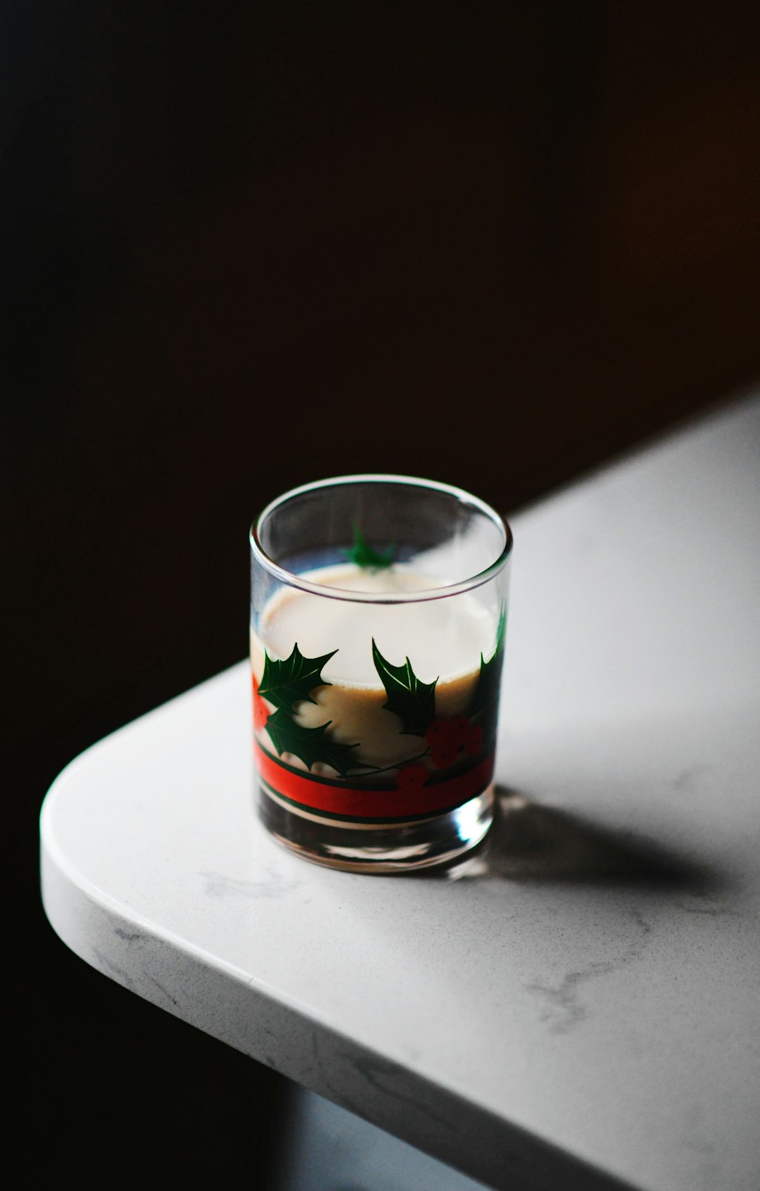 clear drinking glass on white ceramic plate